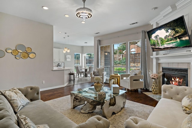 1912 White Oak Rd, Mckinney, TX 75072 - living room featuring a tile fireplace, dark wood-style flooring, baseboards, and recessed lighting