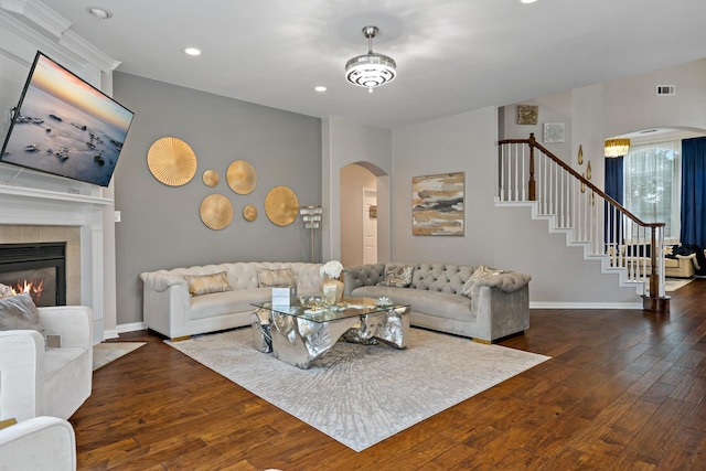 1912 White Oak Rd, Mckinney, TX 75072 - living room with arched walkways, stairs, wood finished floors, a tile fireplace, and recessed lighting