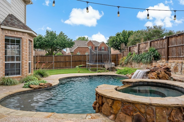 1912 White Oak Rd, Mckinney, TX 75072 - view of swimming pool featuring a fenced backyard, a trampoline, and a pool with connected hot tub