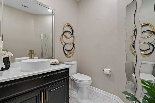 1912 White Oak Rd, Mckinney, TX 75072 - bathroom with toilet, vanity, marble look tiles, and baseboards