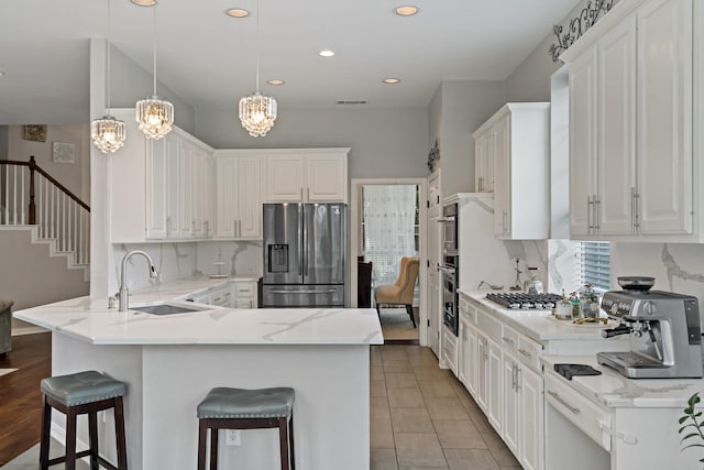 1912 White Oak Rd, Mckinney, TX 75072 - kitchen with stainless steel fridge with ice dispenser, a sink, a peninsula, a chandelier, and a kitchen breakfast bar