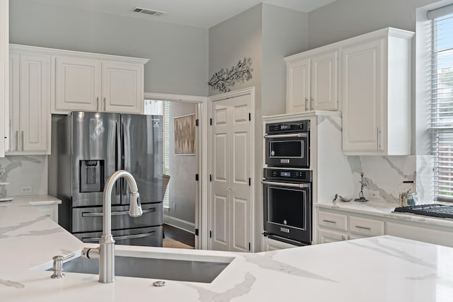 1912 White Oak Rd, Mckinney, TX 75072 - kitchen with stainless steel fridge with ice dispenser, gas cooktop, and white cabinetry