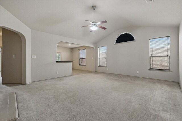 3512 Hornbeam St, Denton, TX 76226 - unfurnished living room with a ceiling fan, arched walkways, lofted ceiling, and light colored carpet