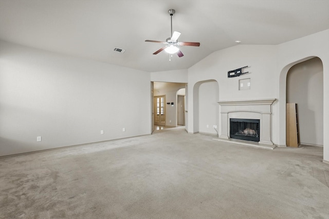 3512 Hornbeam St, Denton, TX 76226 - unfurnished living room with ceiling fan, lofted ceiling, arched walkways, carpet flooring, and a fireplace with raised hearth