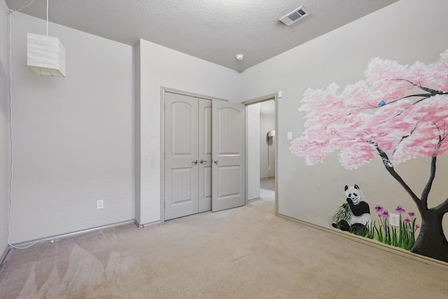 3512 Hornbeam St, Denton, TX 76226 - unfurnished bedroom with carpet, a closet, and a textured ceiling