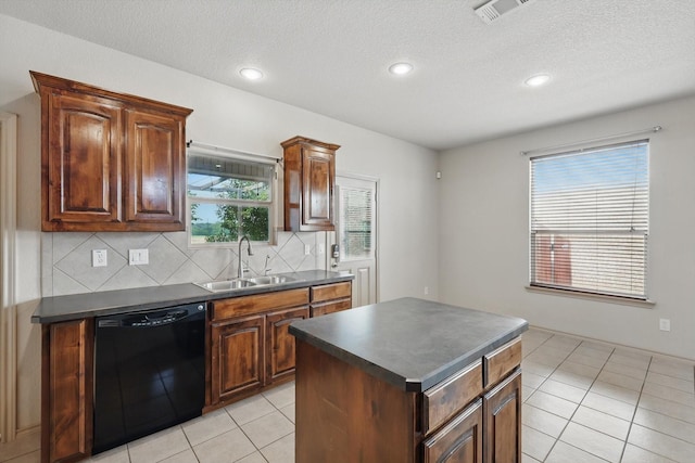 3512 Hornbeam St, Denton, TX 76226 - kitchen featuring black dishwasher, dark countertops, light tile patterned floors, decorative backsplash, and recessed lighting