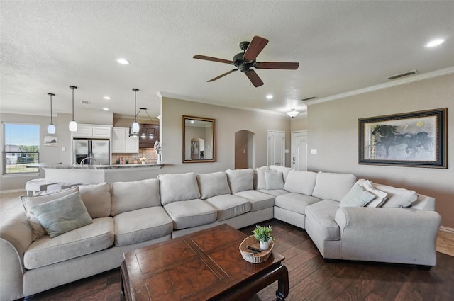1225 County Road 1021, Burleson, TX 76028 - living room with ceiling fan, dark wood finished floors, baseboards, crown molding, and arched walkways