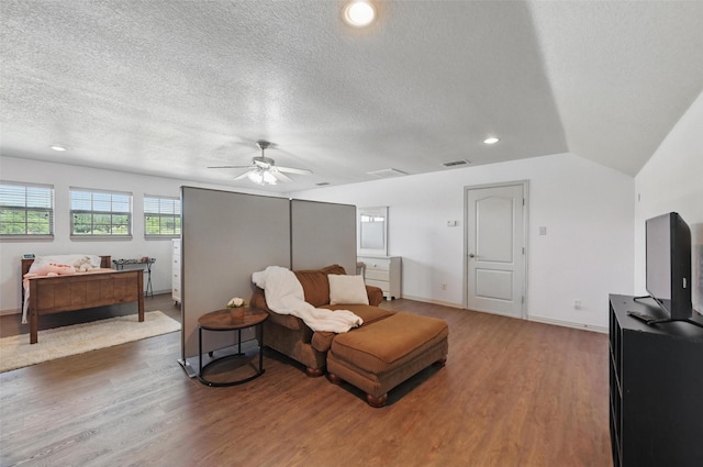 1225 County Road 1021, Burleson, TX 76028 - living room featuring wood finished floors, a ceiling fan, lofted ceiling, a textured ceiling, and recessed lighting