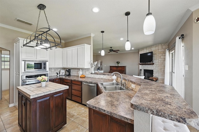 1225 County Road 1021, Burleson, TX 76028 - kitchen with appliances with stainless steel finishes, a sink, ceiling fan, a kitchen island, and backsplash