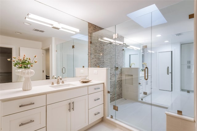 7278 Joyce Way, Dallas, TX 75225 - bathroom featuring a skylight, vanity, a stall shower, and recessed lighting