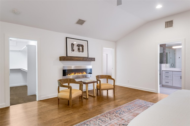7278 Joyce Way, Dallas, TX 75225 - bedroom with lofted ceiling, wood finished floors, a spacious closet, baseboards, and a glass covered fireplace