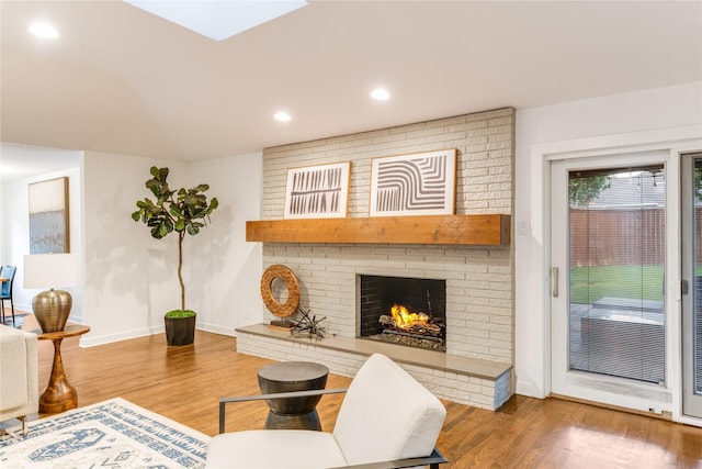 7278 Joyce Way, Dallas, TX 75225 - living area featuring wood finished floors, a brick fireplace, baseboards, recessed lighting, and a skylight