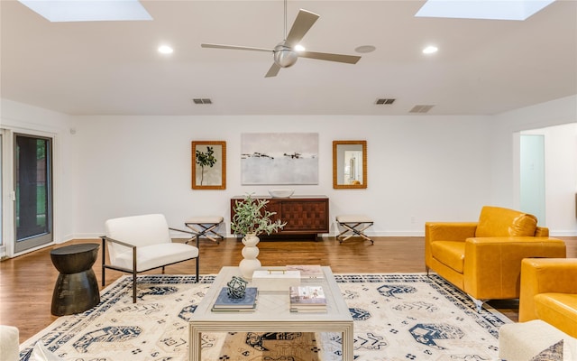 7278 Joyce Way, Dallas, TX 75225 - living room with a skylight, baseboards, wood finished floors, recessed lighting, and ceiling fan