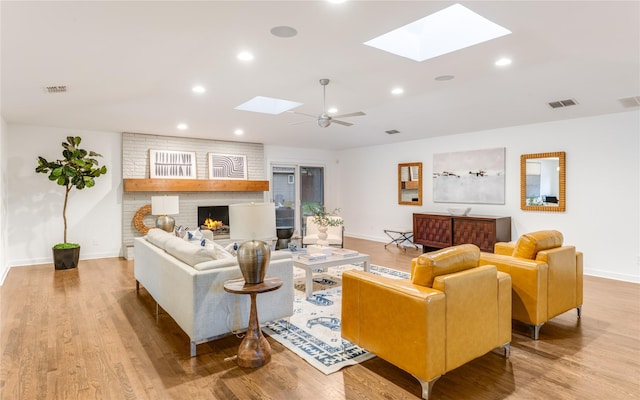 7278 Joyce Way, Dallas, TX 75225 - living room featuring a skylight, baseboards, a fireplace, light wood-type flooring, and recessed lighting