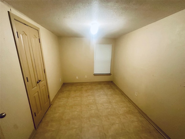 402 N Nash St, Kaufman, TX 75142 - spare room featuring a textured ceiling, light floors, and baseboards