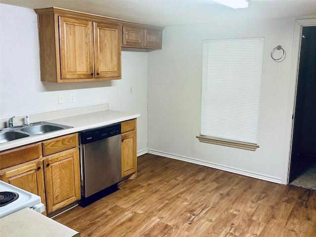 402 N Nash St, Kaufman, TX 75142 - kitchen with dishwasher, a sink, wood finished floors, light countertops, and brown cabinets
