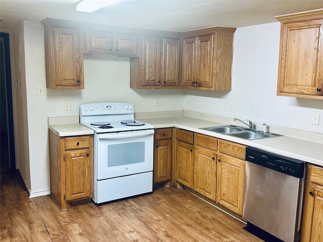 402 N Nash St, Kaufman, TX 75142 - kitchen with white range with electric stovetop, stainless steel dishwasher, a sink, and light wood-type flooring