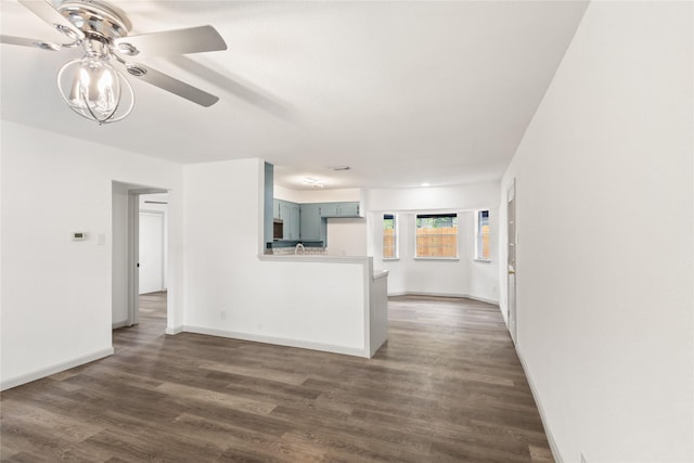3812 David Ln, Forest Hill, TX 76119 - unfurnished living room with ceiling fan, dark wood-type flooring, and baseboards