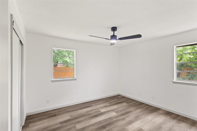 3812 David Ln, Forest Hill, TX 76119 - unfurnished bedroom featuring multiple windows, wood finished floors, a closet, and baseboards