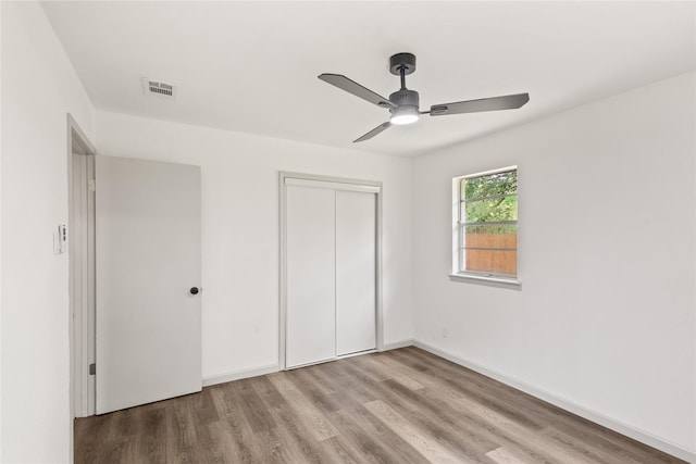 3812 David Ln, Forest Hill, TX 76119 - unfurnished bedroom with wood finished floors, a closet, a ceiling fan, and baseboards