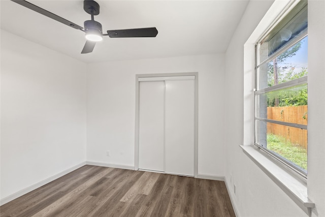 3812 David Ln, Forest Hill, TX 76119 - unfurnished bedroom featuring multiple windows, wood finished floors, a closet, and baseboards