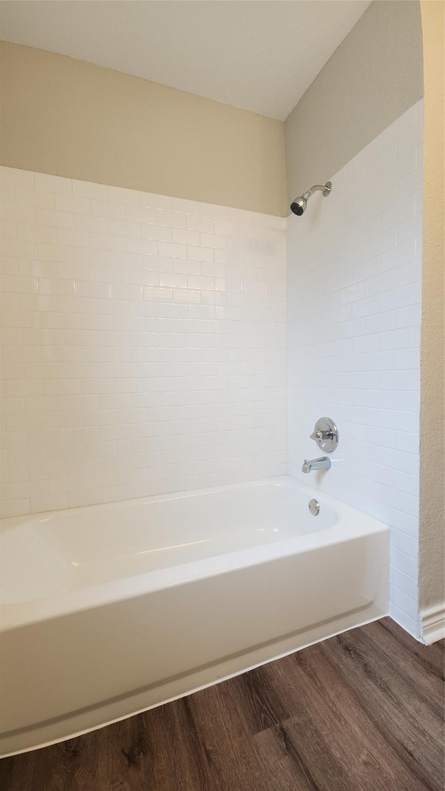 3308 29th St, Fort Worth, TX 76111 - bathroom featuring wood finished floors and shower / washtub combination