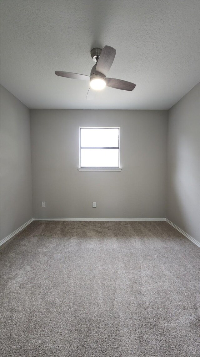 3308 29th St, Fort Worth, TX 76111 - carpeted empty room with ceiling fan, a textured ceiling, and baseboards