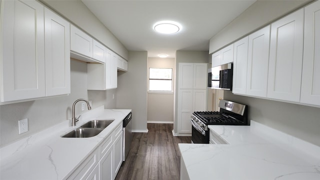 3308 29th St, Fort Worth, TX 76111 - kitchen with a sink, appliances with stainless steel finishes, baseboards, white cabinets, and light stone counters