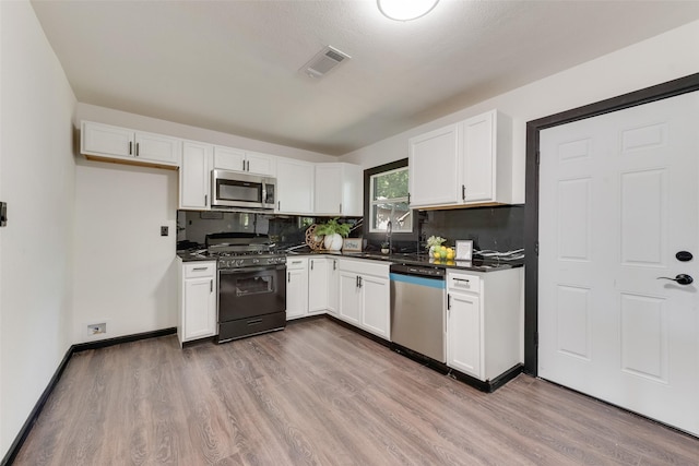 3467 Binyon St, Fort Worth, TX 76133 - kitchen featuring stainless steel appliances, dark countertops, a sink, and white cabinetry