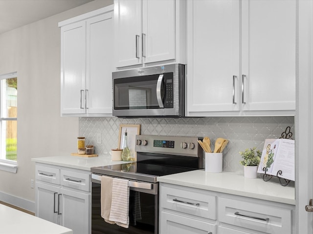 4416 Green Acres Ct, Arlington, TX 76017 - kitchen featuring appliances with stainless steel finishes, white cabinets, light countertops, and tasteful backsplash