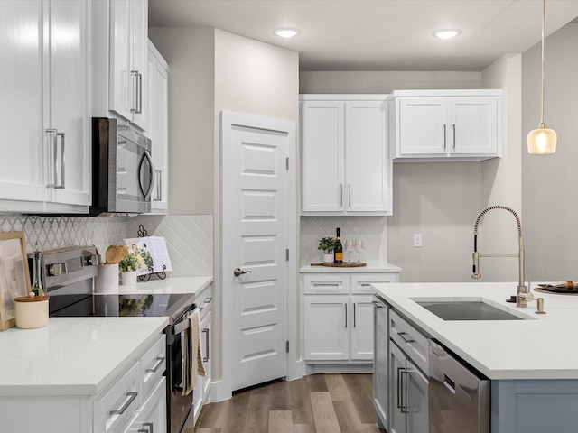 4416 Green Acres Ct, Arlington, TX 76017 - kitchen featuring stainless steel appliances, a sink, dark wood-type flooring, white cabinetry, and backsplash