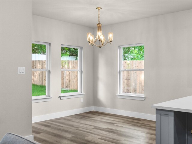 4416 Green Acres Ct, Arlington, TX 76017 - unfurnished dining area with a chandelier, healthy amount of natural light, and wood finished floors