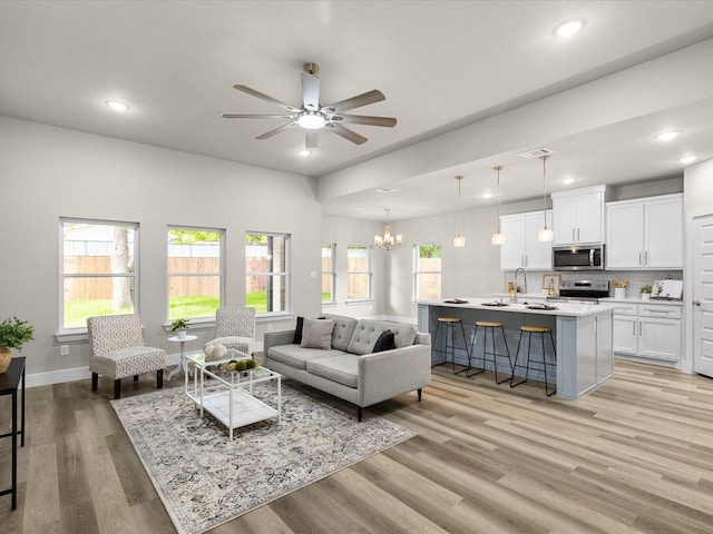 4416 Green Acres Ct, Arlington, TX 76017 - living area with ceiling fan, recessed lighting, light wood finished floors, a chandelier, and baseboards