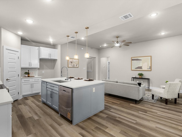 4416 Green Acres Ct, Arlington, TX 76017 - kitchen featuring a sink, stainless steel dishwasher, white cabinetry, open floor plan, and wood finished floors