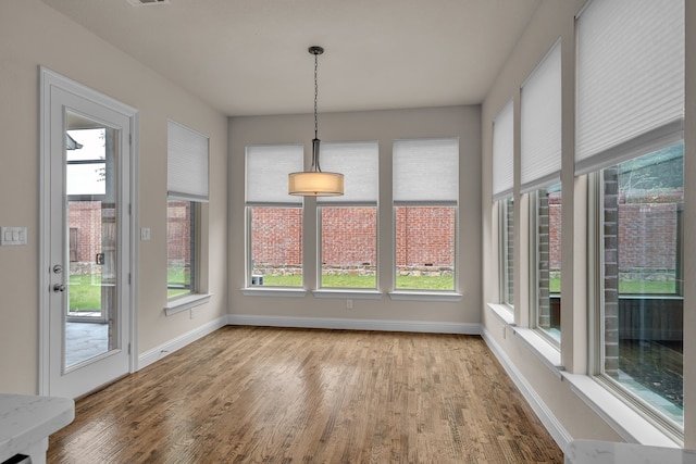 7819 Uxbridge Dr, Irving, TX 75063 - unfurnished sunroom featuring wood finished floors and baseboards