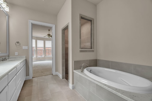 7819 Uxbridge Dr, Irving, TX 75063 - bathroom with a garden tub, double vanity, a ceiling fan, tile patterned flooring, and baseboards