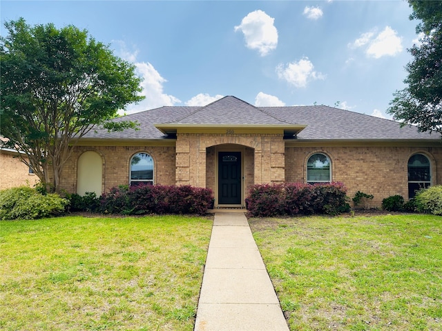 250 E Bancroft Dr, Garland, TX 75040 - view of front facade featuring a shingled roof, a front lawn, and brick siding