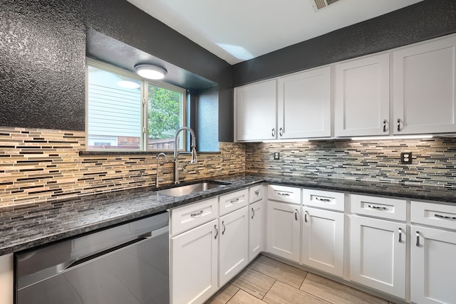 250 E Bancroft Dr, Garland, TX 75040 - kitchen with stainless steel dishwasher, a sink, decorative backsplash, white cabinets, and dark stone countertops