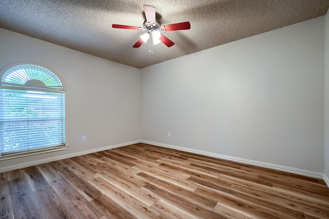 250 E Bancroft Dr, Garland, TX 75040 - spare room with healthy amount of natural light, ceiling fan, wood finished floors, a textured ceiling, and baseboards