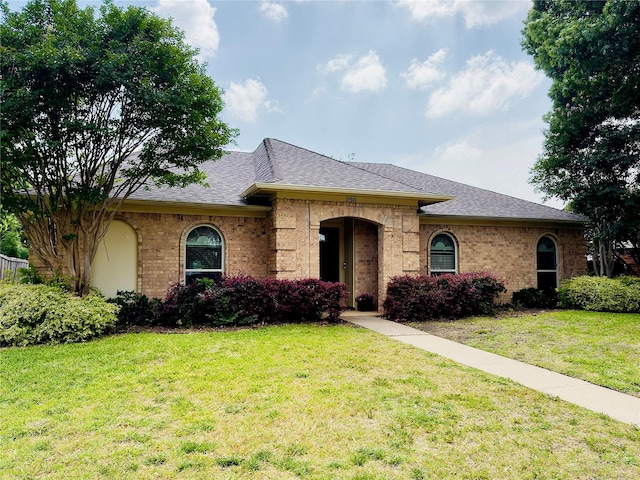 250 E Bancroft Dr, Garland, TX 75040 - view of front of house with roof with shingles, a front lawn, and brick siding