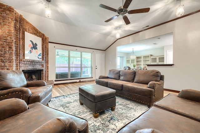 250 E Bancroft Dr, Garland, TX 75040 - living area with wood finished floors, ceiling fan, a fireplace, lofted ceiling, and ornamental molding