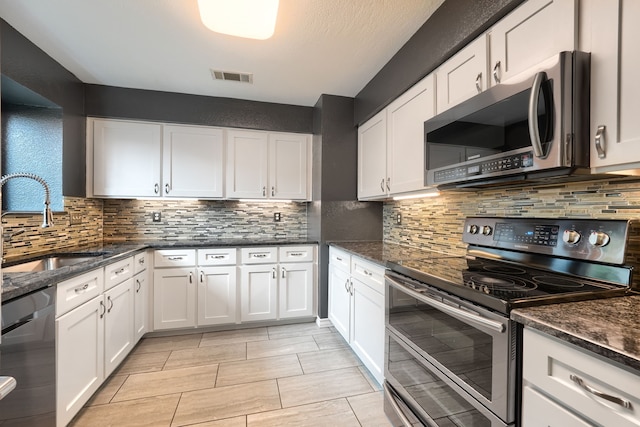 250 E Bancroft Dr, Garland, TX 75040 - kitchen with appliances with stainless steel finishes, a sink, and white cabinets