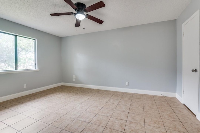 6646 E Lovers Ln Unit 1510, Dallas, TX 75214 - empty room with a textured ceiling, a ceiling fan, light tile patterned flooring, and baseboards