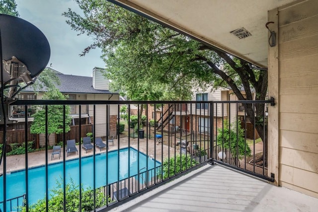 6646 E Lovers Ln Unit 1510, Dallas, TX 75214 - balcony with view of pool, a patio area, and stairs