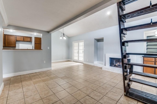 6646 E Lovers Ln Unit 1510, Dallas, TX 75214 - unfurnished living room featuring a brick fireplace, light tile patterned floors, beamed ceiling, baseboards, and a chandelier