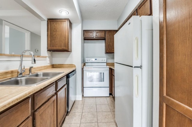 6646 E Lovers Ln Unit 1510, Dallas, TX 75214 - kitchen with white appliances, a sink, light countertops, light tile patterned floors, and a textured ceiling
