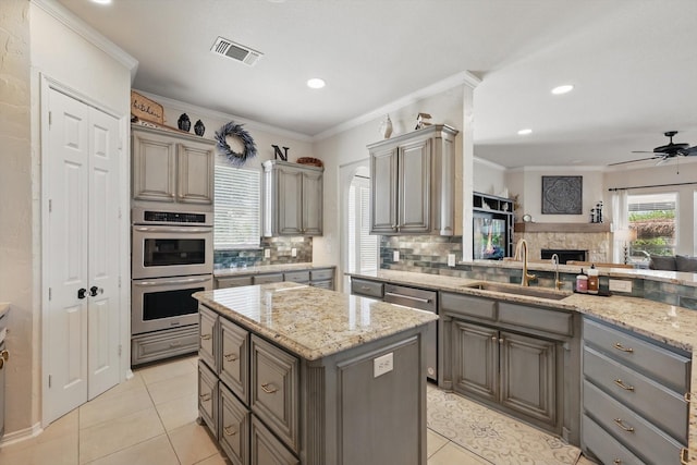 1000 Van Zandt Ct, Haslet, TX 76052 - kitchen with gray cabinets, appliances with stainless steel finishes, a sink, backsplash, and light tile patterned floors