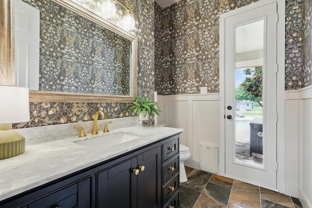 1000 Van Zandt Ct, Haslet, TX 76052 - bathroom with vanity, a decorative wall, toilet, and wainscoting