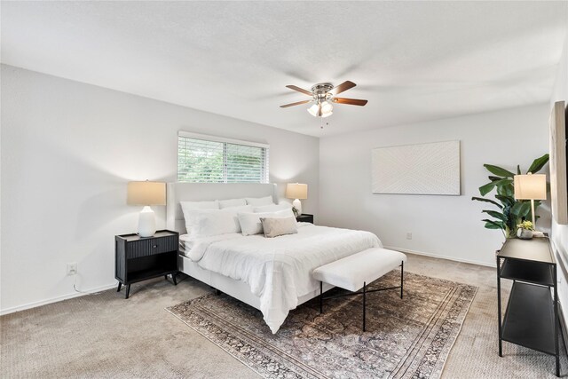 3309 Citation Dr, Dallas, TX 75229 - bedroom with light carpet, a ceiling fan, and baseboards