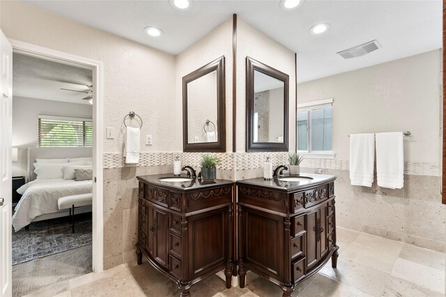 3309 Citation Dr, Dallas, TX 75229 - ensuite bathroom featuring tile walls, double vanity, ceiling fan, recessed lighting, and a wainscoted wall